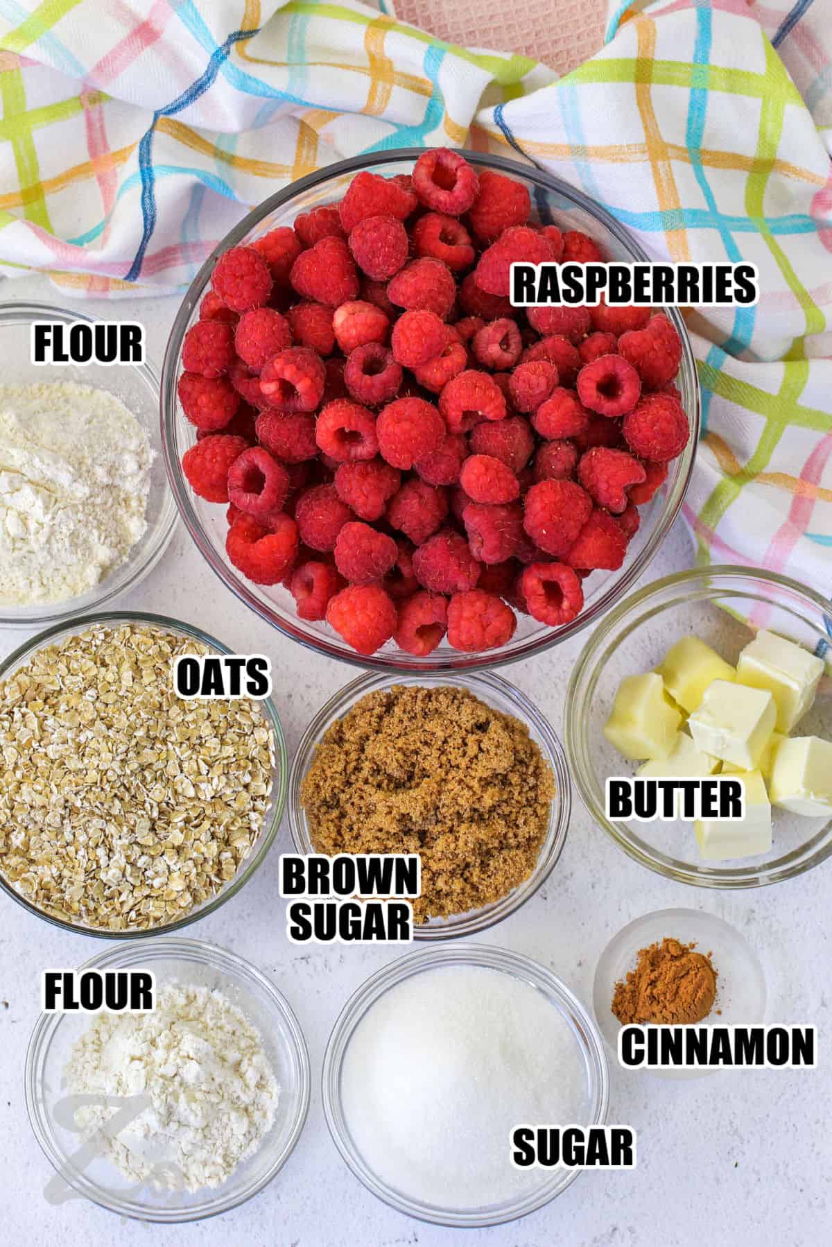 raspberries, butter, cinnamon, sugar, brown sugar, flour and oats assembled to make raspberry crisp