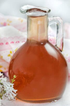 a jar of lilac simple syrup