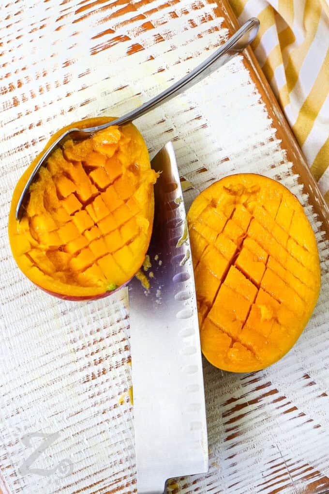 slicing mangoes to make Mango Salsa