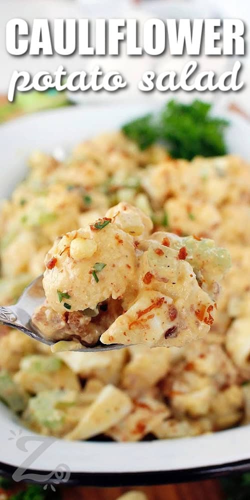 a spoonful of cauliflower potato salad with a title