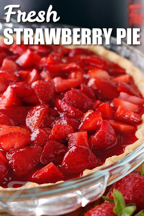 close up of fresh strawberry pie, made with glaze covered strawberries in a baked pie shell, with a title