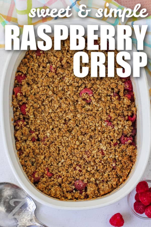 baked raspberry crisp in a white baking dish, with a title