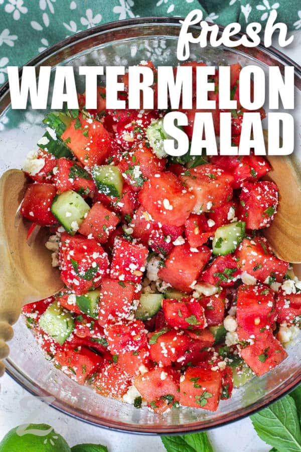 Watermelon Salad in a bowl with spoons and writing