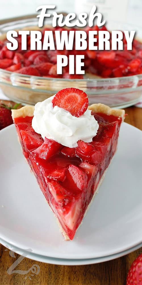 Fresh strawberry pie with whipped cream and a sliced strawberry on top, with a title