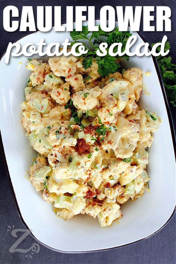 cauliflower potato salad in a white rectangular dish, garnished with parsley, with a title