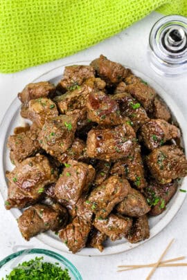 steak bites with garlic butter on a plate with parsley