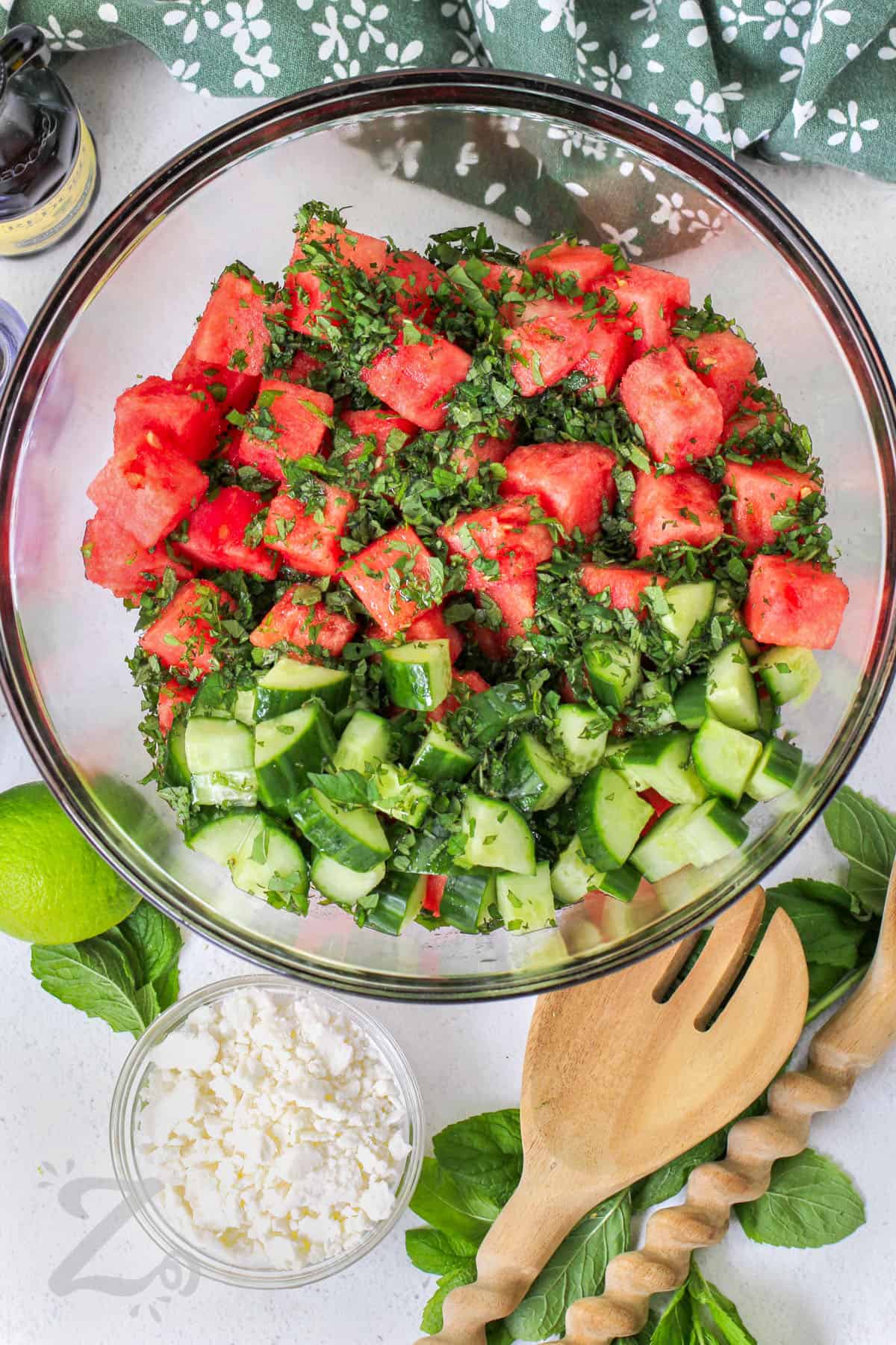 adding ingredients to bowl to make Watermelon Salad