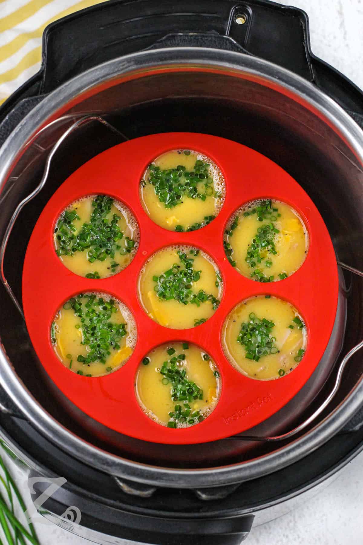 egg with chives ham and cheese in egg molds in the instant pot to make Instant Pot Egg Bites