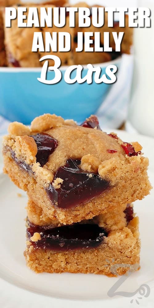 two peanut butter and jelly bars stacked on a white plate, with more bars in a blue bowl in the background, with a title