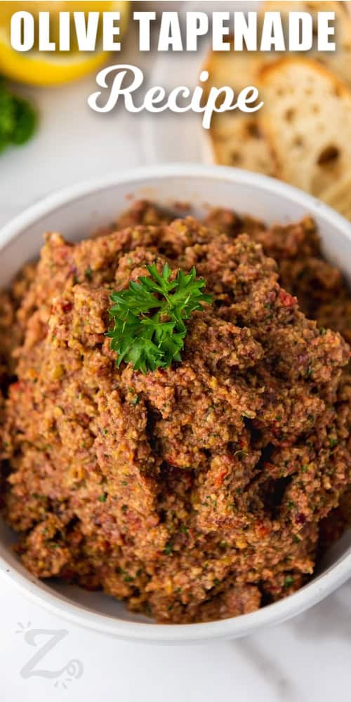 Olive Tapenade, garnished with fresh parsley, in a bowl with text