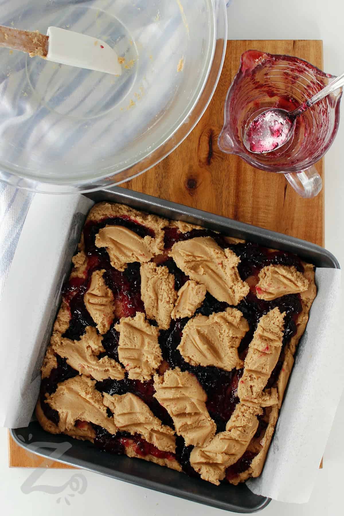 jelly added on top of the creamed mixture and the remaining dough plopped on top in the process to make peanut butter and jelly bars