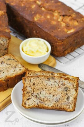 slices of Fresh Pear Bread on a plate with loaf in the back