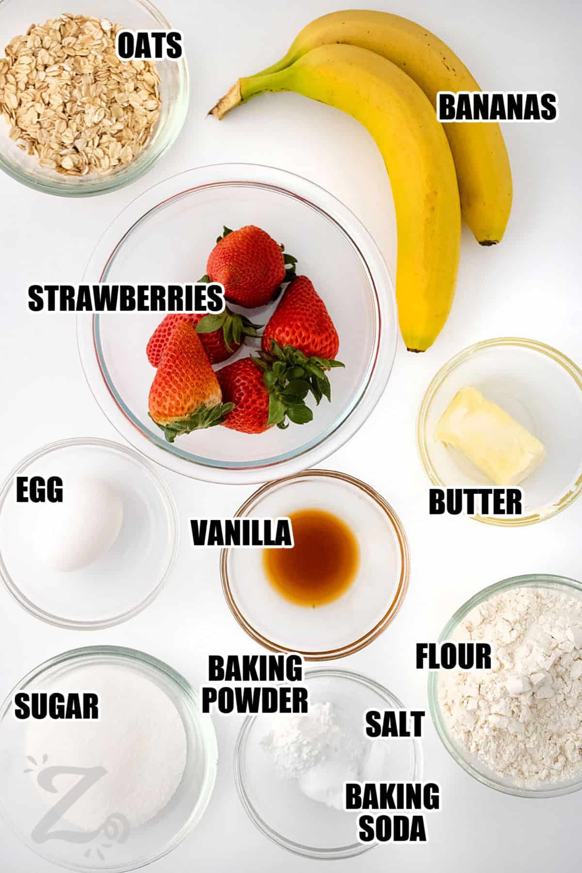 oats , bananas , strawberries , butter , vanilla , egg , sugar , baking powder , baking soda , salt and flour with labels to make Strawberry Banana Muffins