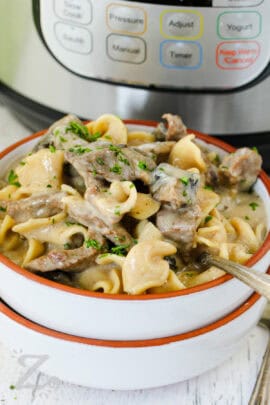 bowl of Instant Pot Beef Stroganoff with a fork