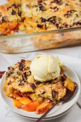 Peach Dump Cake recipe on a plate with ice cream