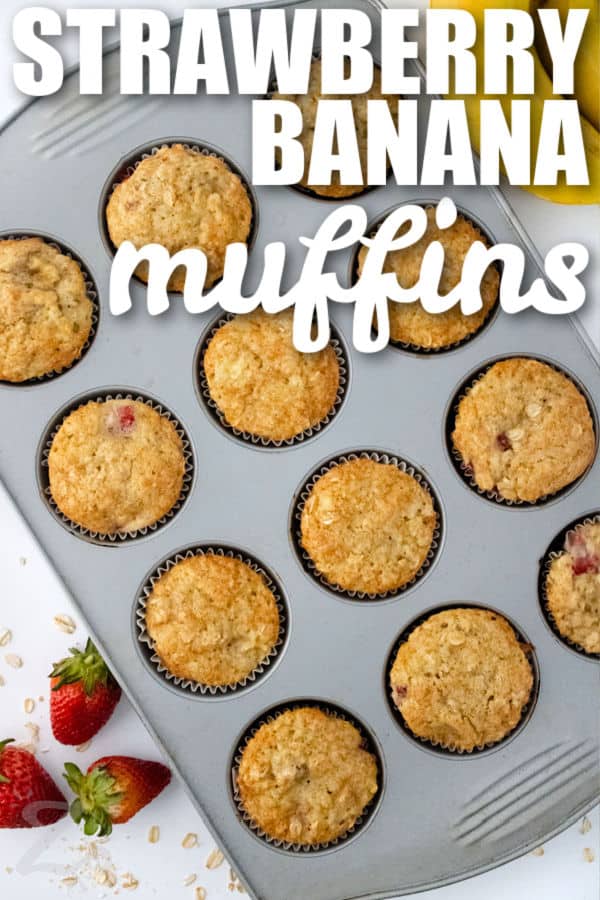 baked Strawberry Banana Muffins in the tin with writing