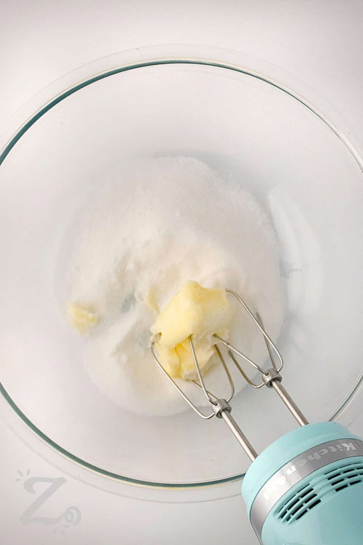 adding butter to sugar to make Strawberry Banana Muffins