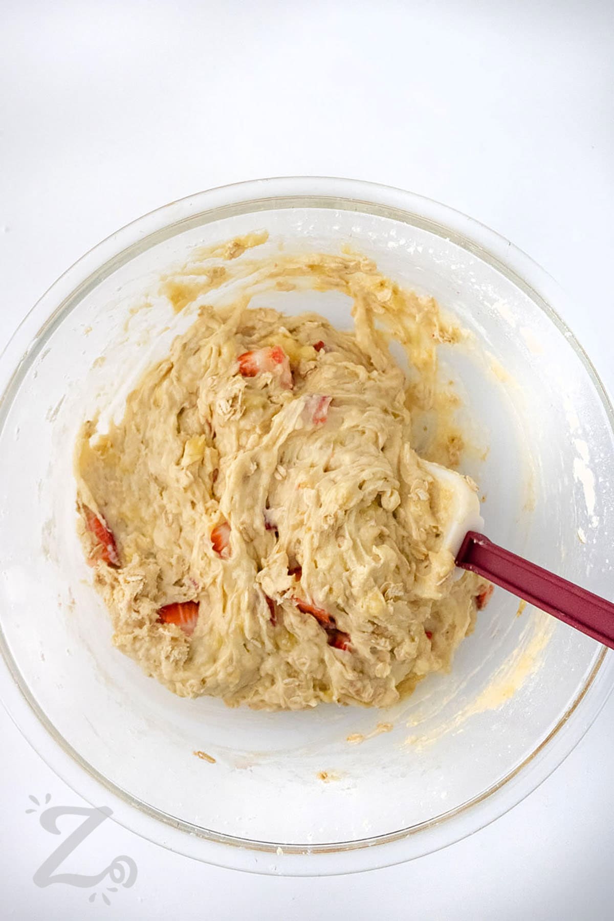 mixing ingredients to make Strawberry Banana Muffins