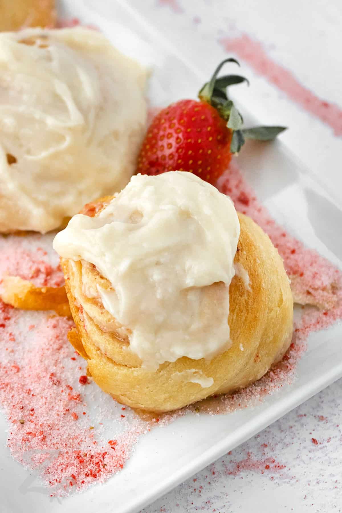 close up of Strawberry Cinnamon Rolls on a plate