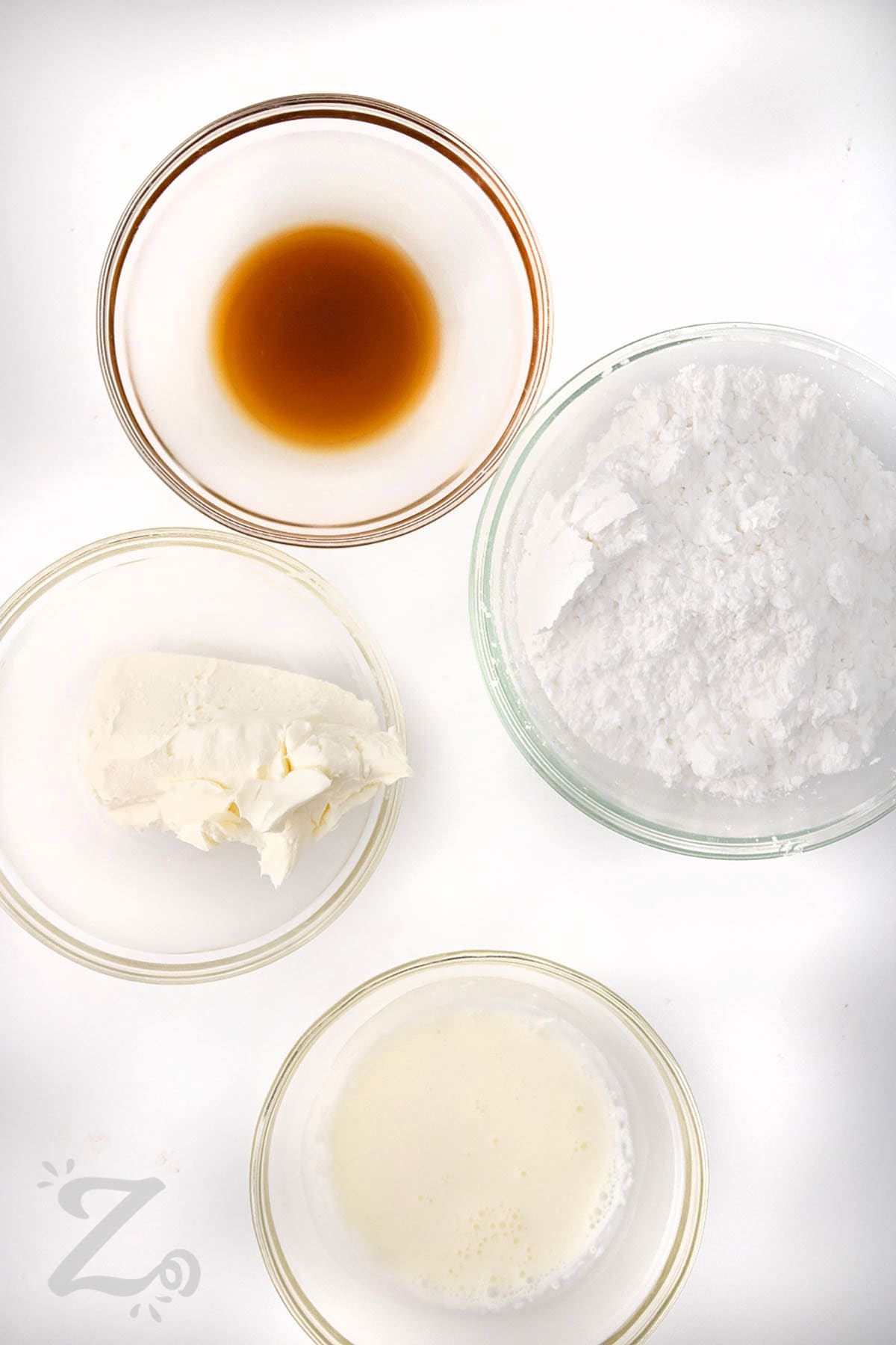 ingredients in bowls to make cream cheese frosting for Strawberry Cinnamon Rolls