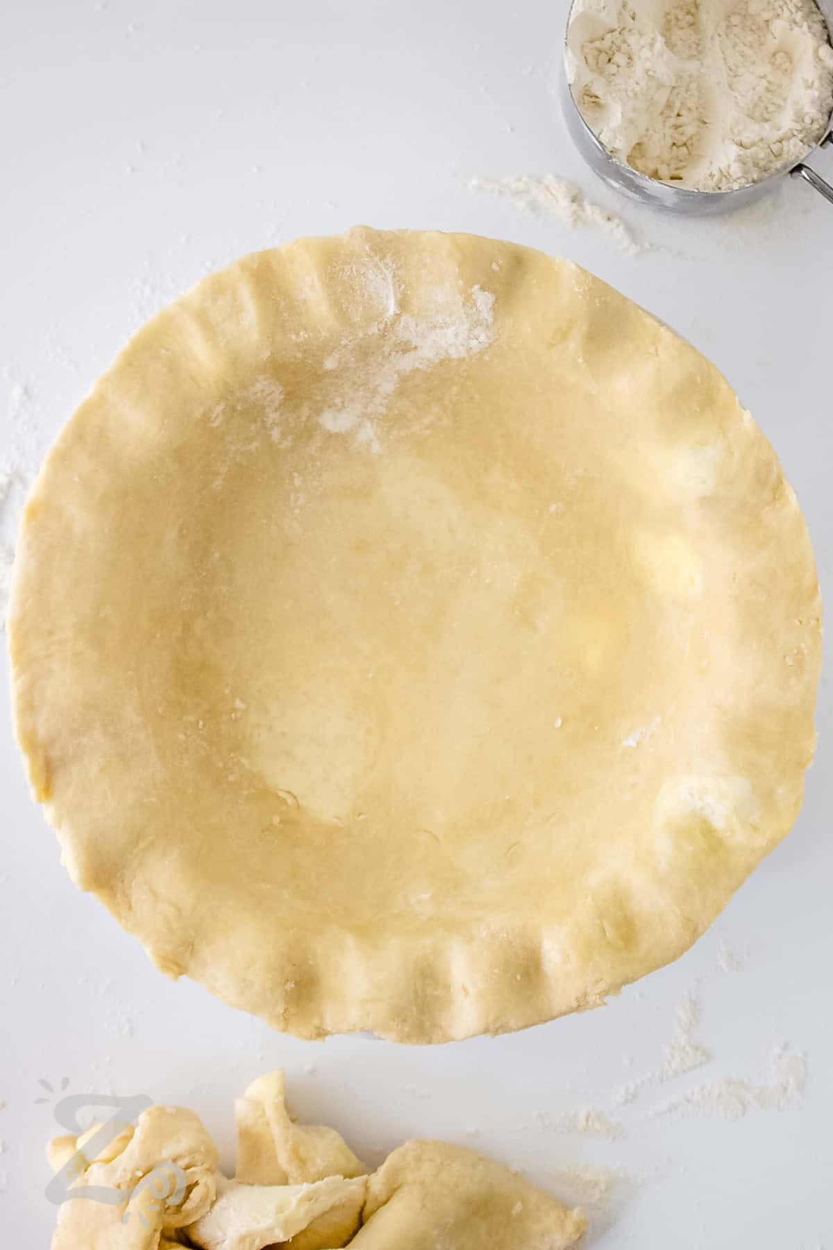 adding Easy Pie Crust to the pie tin