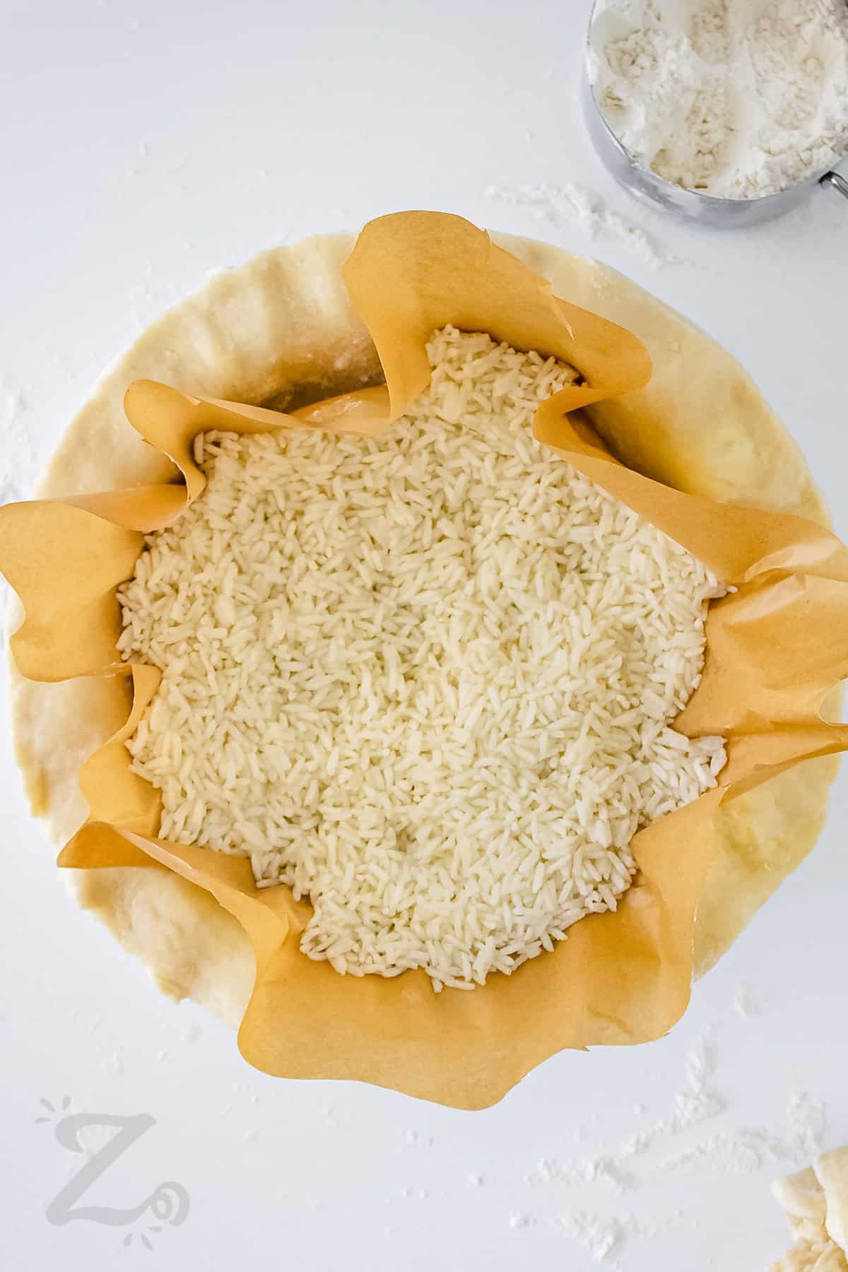 adding rice to Easy Pie Crust to weigh it down and shape