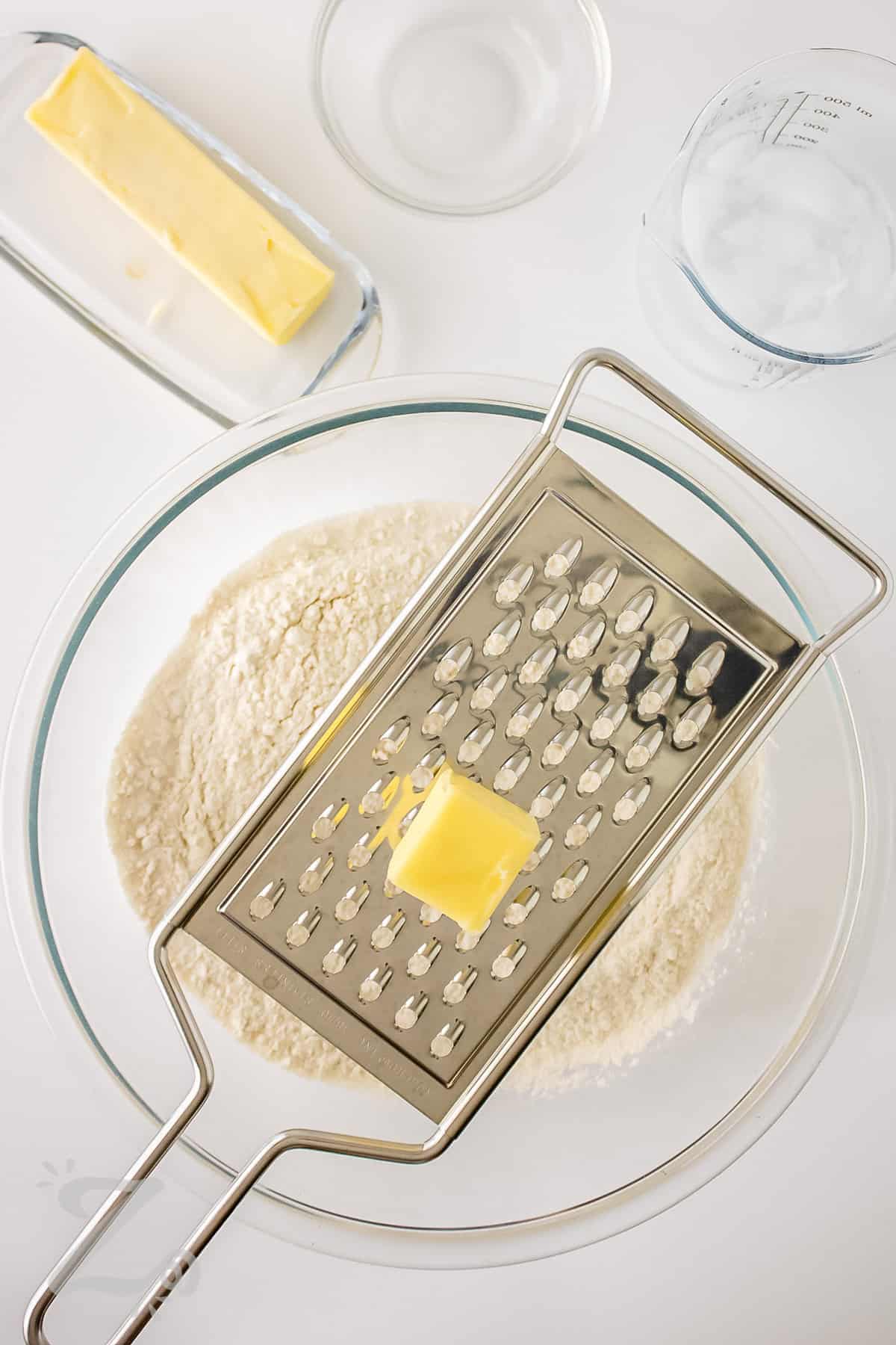 grating butter into dry ingredients to make Easy Pie Crust