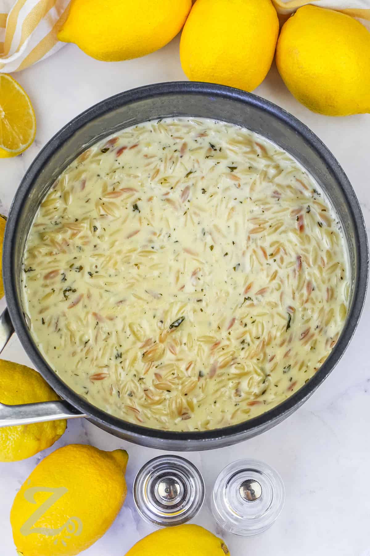 adding cream to pot to make Lemon Chicken Orzo