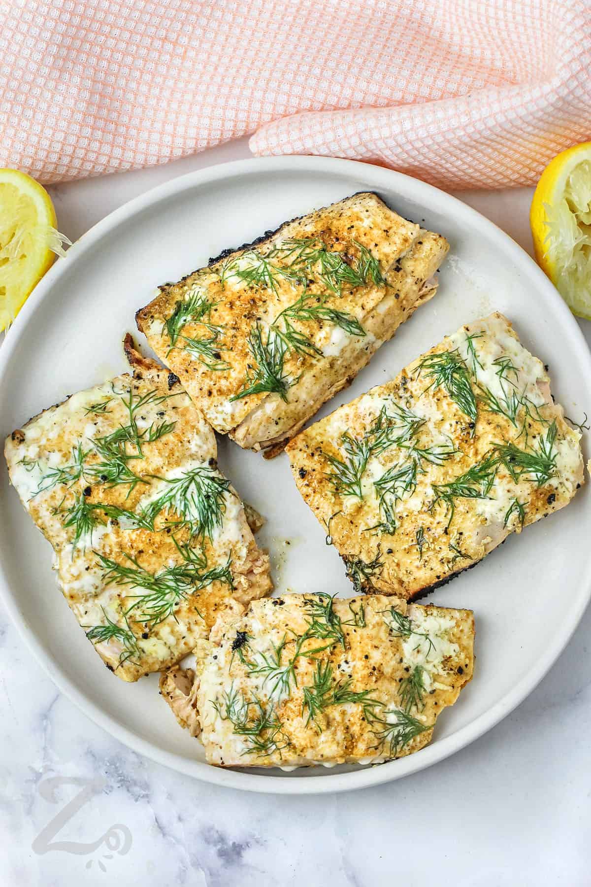 easy Pan Seared Salmon Filets with dill and lemon on a plate