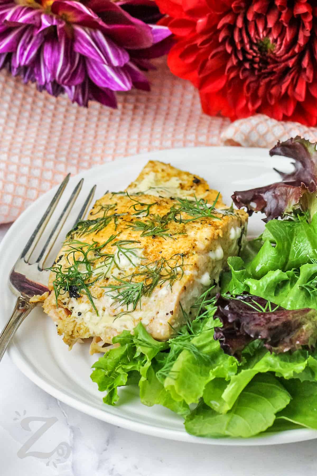 plated Pan Seared Salmon Filets with a salad