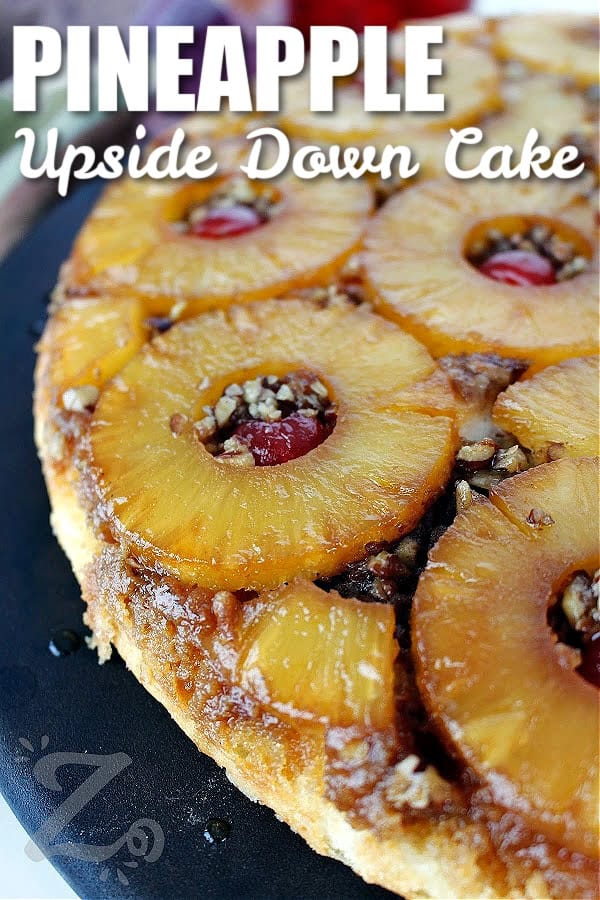 homemade pineapple upside down cake on on a platter, with a title