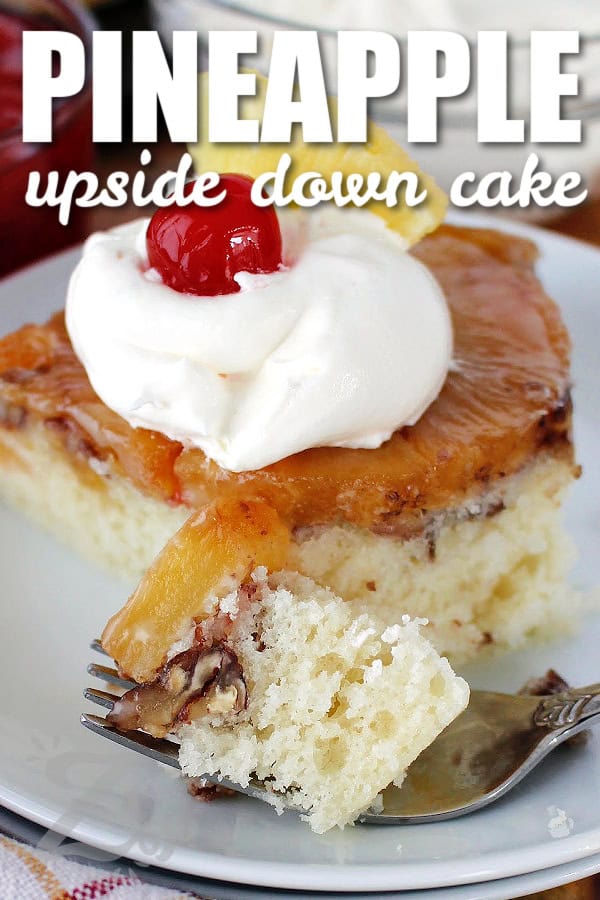 a slice of homemade pineapple upside down cake, garnished with whipped cream, a maraschino cherry, and a chunk of pineapple, on a white plate with a title