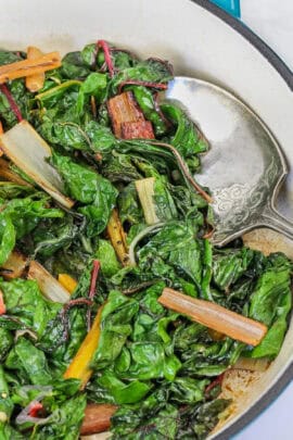 close up of Swiss Chard in a pan with a spoon