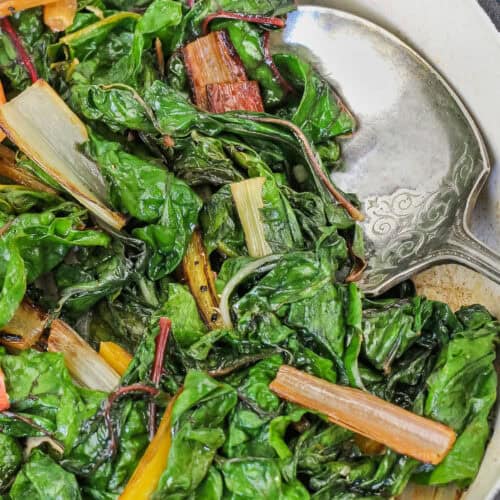 close up of Swiss Chard in a pan with a spoon