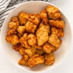 A serving bowl of chicken nuggets
