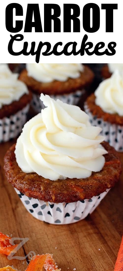 A rich and creamy frosting is key to the best carrot cupcakes. Whip softened cream cheese and butter until smooth before adding the lemon juice and vanilla.. Sift powdered sugar before mixing to prevent lumps, and add it gradually to reach the perfect consistency. For easy piping, chill the frosting for 15 minutes before decorating. #ourzestylife carrot cupcakes on a wooden board with a title