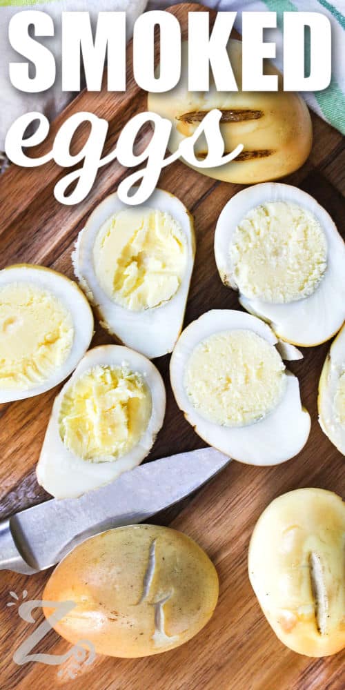 Smoked Eggs on a cutting board with a few cut in halves and a title