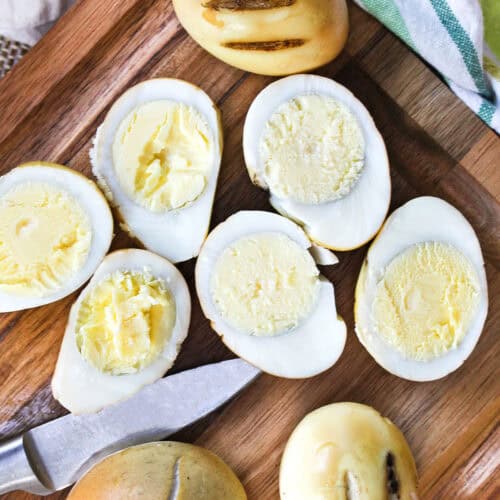 Smoked Eggs on a cutting boar with a knife