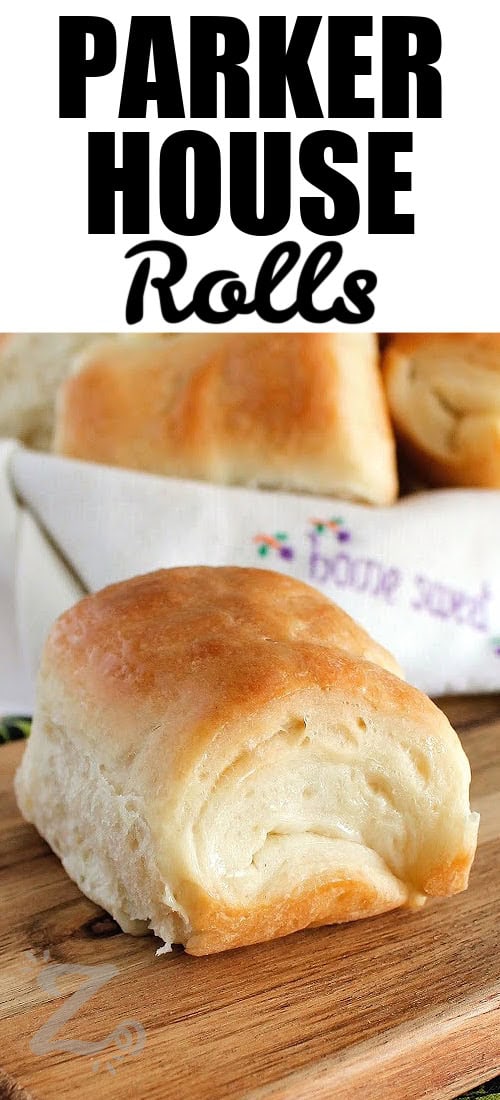 a roll sitting on a wooden board, with Parker House Rolls in a basket in the background, with a title
