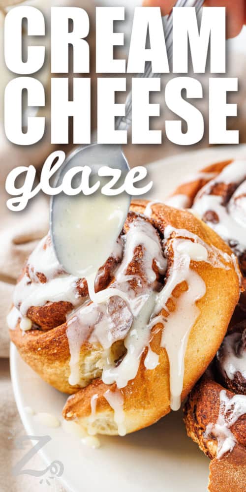 cream cheese glaze being drizzled with a spoon and writing