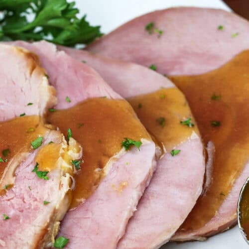 gravy on slices of Slow Cooker Ham