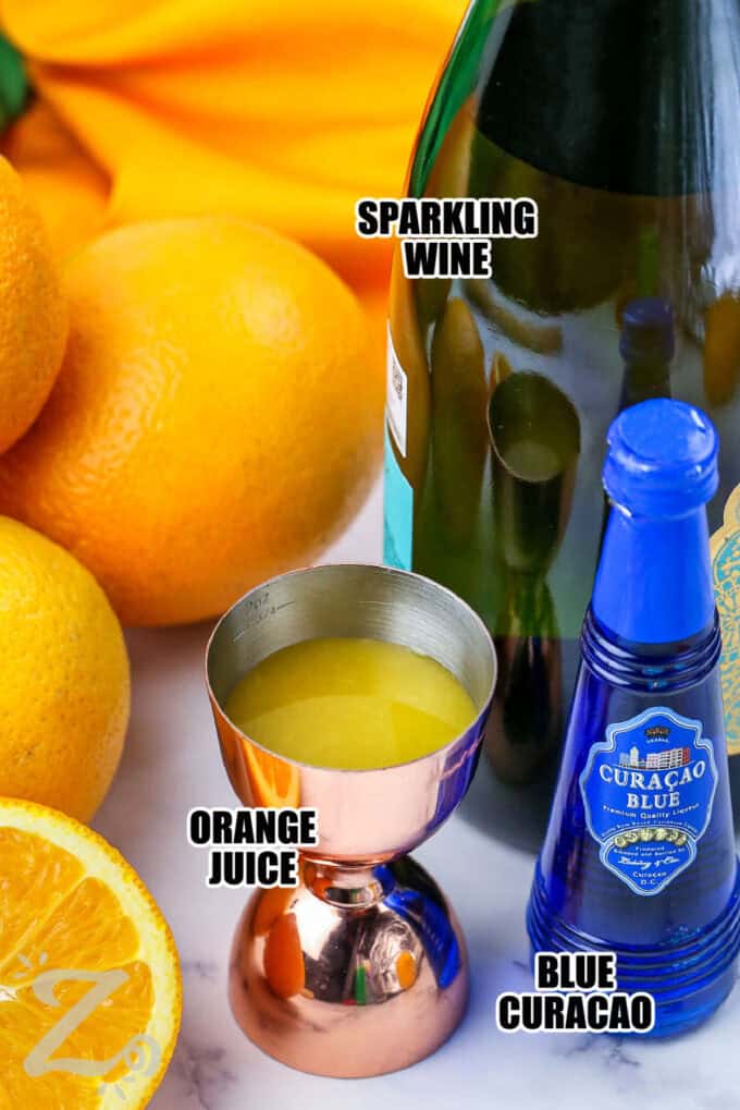 sparkling wine , orange juice and blue curacao with labels to make Green Mimosa