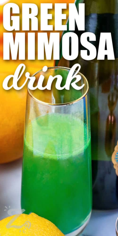 Green Mimosa drink in a glass with writing
