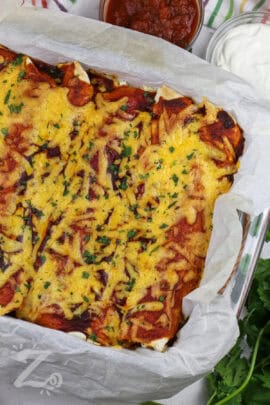 cheesy Easy Chicken Enchiladas in a casserole dish