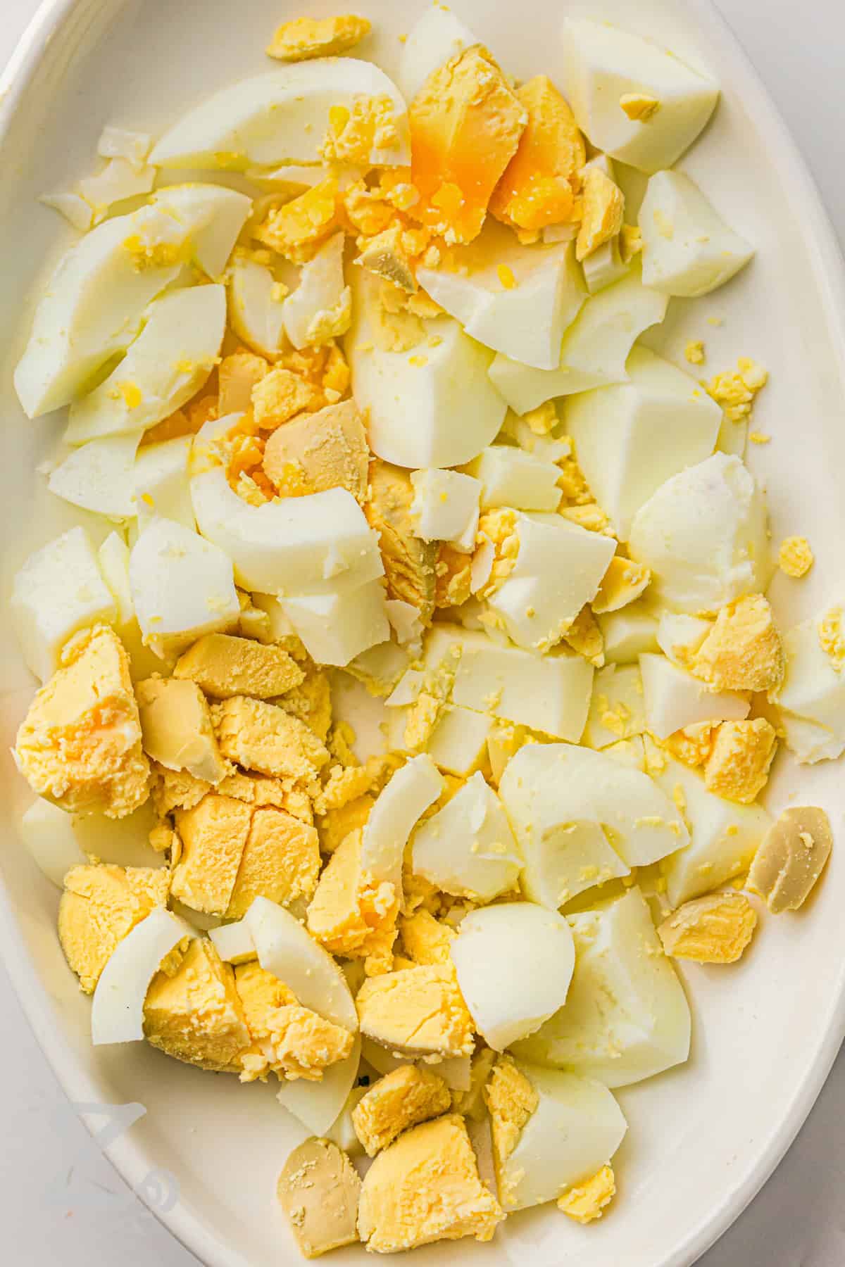 Classic potato salad recipe lovers will want this creamy side dish at every cookout. Tender potatoes, chopped eggs, crisp celery, and onion are tossed in a rich mustard mayo dressing for the perfect balance of flavor. This homemade potato salad is great for picnics, backyard barbecues, and family dinners. It tastes even better after chilling and pairs well with burgers, fried chicken, or sandwiches. #ourzestylife chopped eggs to make Classic Potato Salad