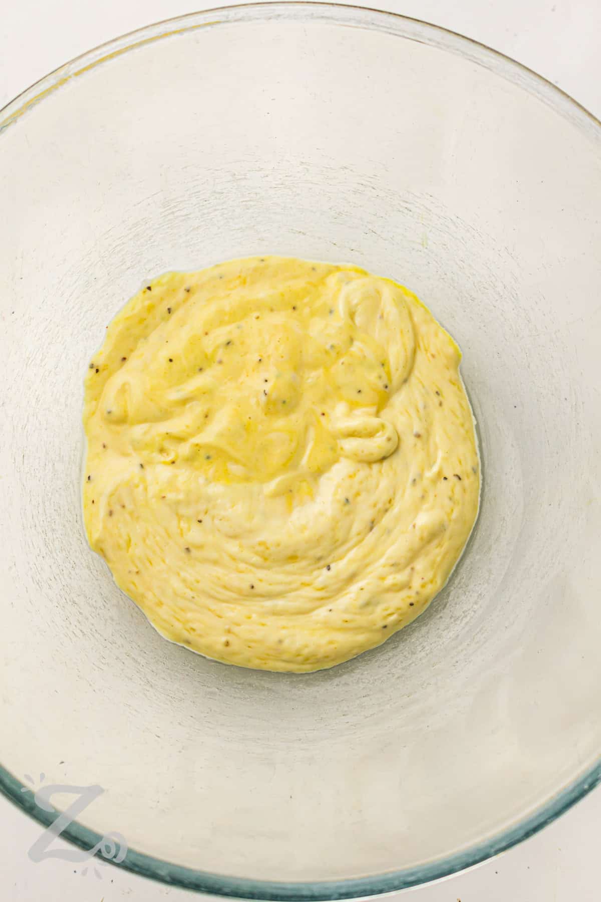 Classic potato salad recipe lovers will keep coming back to this easy homemade version. Tender potatoes and hard-boiled eggs are combined with celery and onion in a creamy mustard mayo dressing. This old-fashioned potato salad is perfect for family cookouts, summer picnics, and holiday gatherings. It tastes delicious served cold with burgers, fried chicken, or grilled meats. #ourzestylife dressing for Classic Potato Salad in bowl