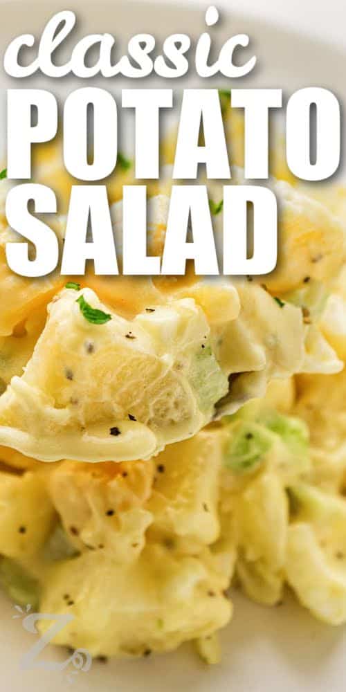 Classic potato salad recipe fans love this cool and creamy side dish for warm-weather meals. Tender potatoes, eggs, celery, and onion are coated in a homemade mayo mustard dressing with simple pantry ingredients. This easy potato salad is great for summer cookouts, picnics, and potlucks. Make it ahead for stress-free entertaining and serve it with burgers, barbecue ribs, or fried chicken. #ourzestylife creamy Classic Potato Salad with writing