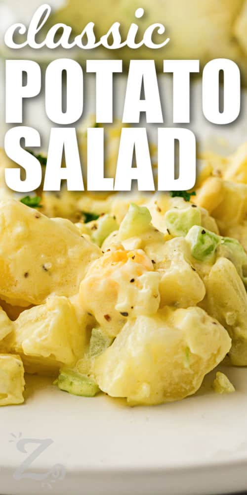 Classic potato salad recipe ideas do not get much better than this creamy and hearty version. Bite-sized potatoes and chopped eggs are mixed with celery and onion in a smooth mustard mayo dressing full of homemade flavor. This cold potato salad is a favorite for backyard barbecues, picnics, and easy family dinners. Serve it with grilled chicken, burgers, or crispy fried foods. #ourzestylife close up of Classic Potato Salad with a title