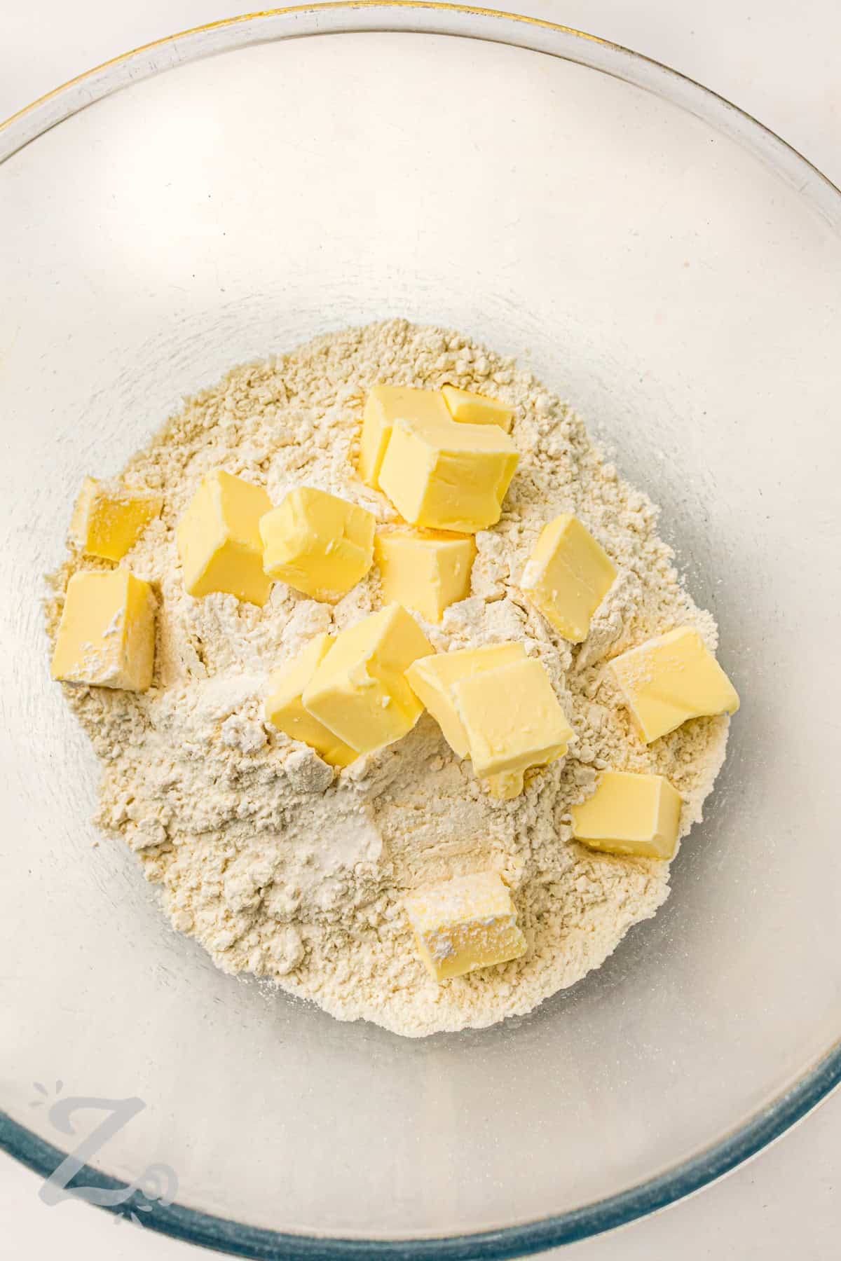 adding butter to flour mixture to make Strawberry Shortcake