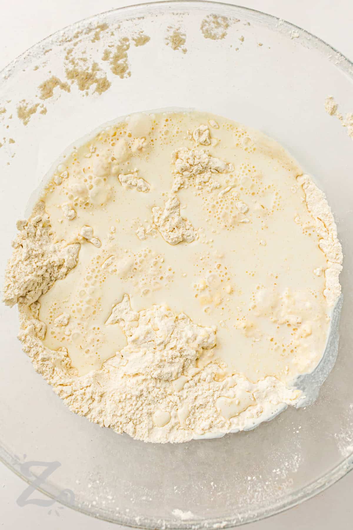 adding wet and dry ingredients together to make shortcakes for Strawberry Shortcake